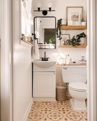 small modern bathroom with patterned floors and floating shelves