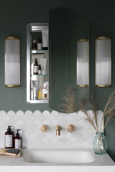 Brass Bathroom Faucet in green bathroom with scallop tiles and vintage style brass faucet