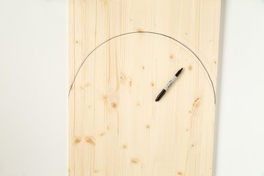 Marking an arch shape with marker on wood board