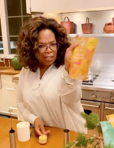 oprah holding a bag of clevr golden superlatte gifted by meghan markle