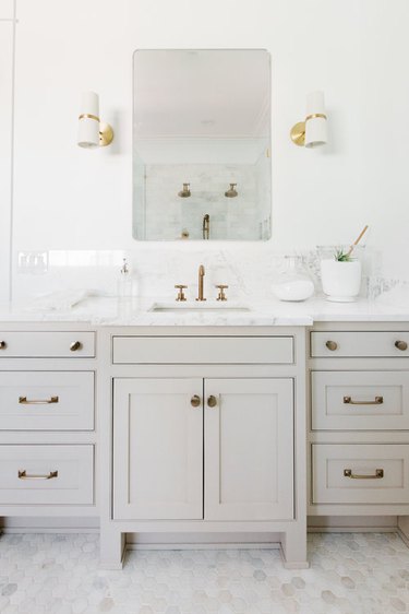 Brass Bathroom Faucet in gray white and marble bathroom with brass faucet