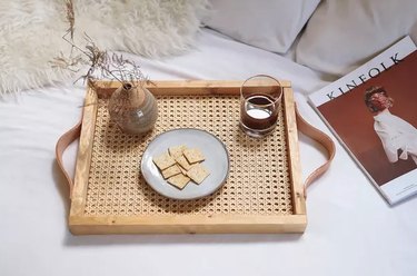 Cane and wood tray on bed