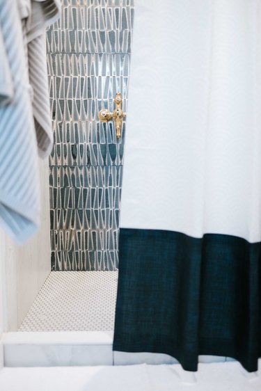 Triangle-shaped blue shower tile in midcentury modern shower