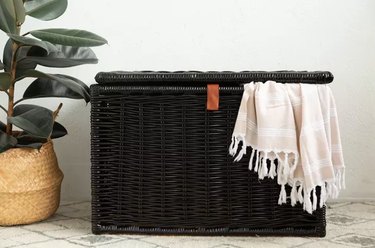 Black painted wicker trunk/chest with blanket