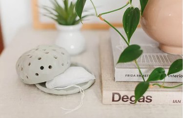 Air dry clay diffuser on cabinet with plants and books
