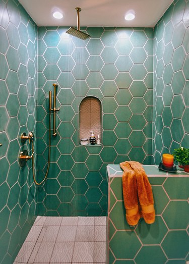 Green tile shower in hexagon shapes with rain shower showerhead