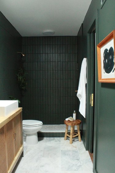 Green tile shower in dark green ceramic with matching dark green walls