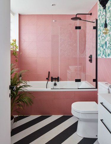 modern bathroom with pink tiles and black and white floors