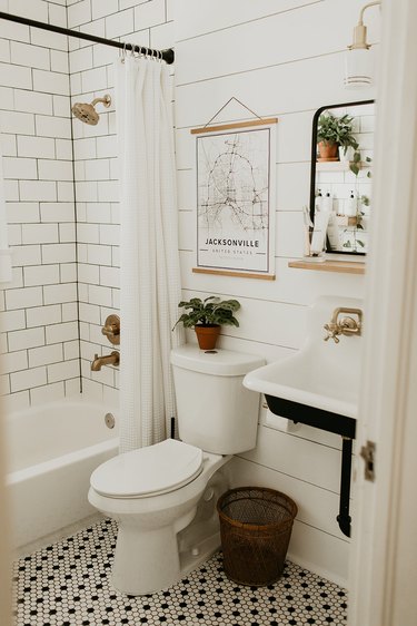 Industrial bathroom with white subway tile and white shiplap wall