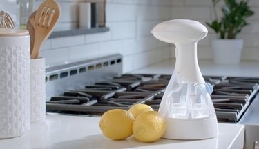 o3waterworks sanitizing spray bottle with lemons on kitchen counter