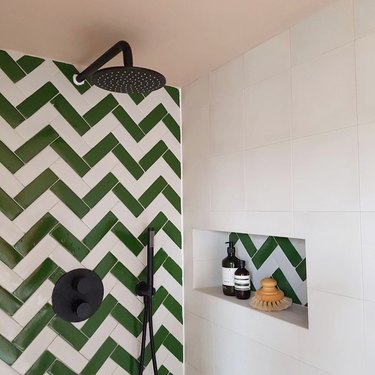 Green tile shower with green and white herringbone stripes