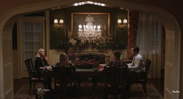 people in dining room with chandelier