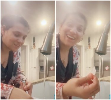 woman using hot water to get wax off silver candle holder