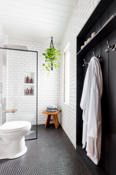 Industrial Bathroom Storage in black and white industrial bathroom with coat hooks