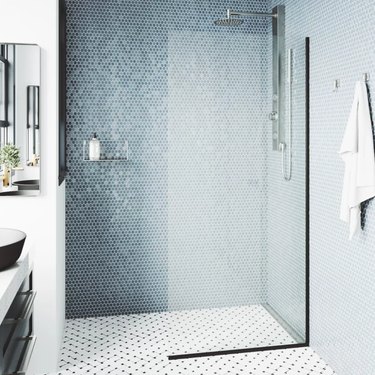 Blue shower tile seen in modern glass shower