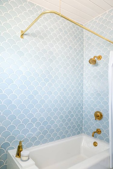 Light blue shower tile with brass accents in shower