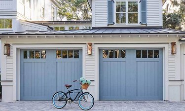 gray house exterior with blue carriage style garage doors