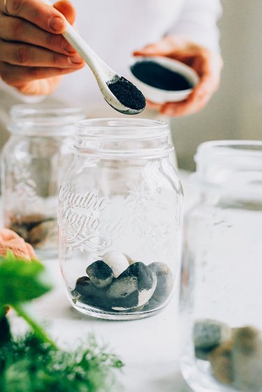 Add activated charcoal on top of stones in mason jar herb garden
