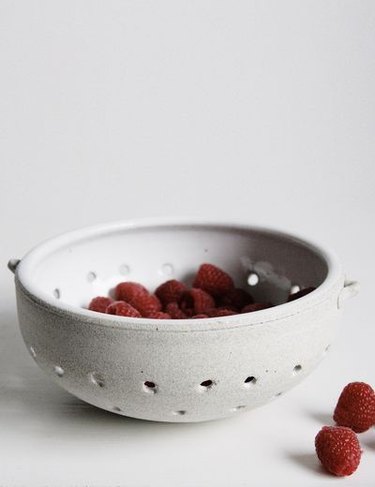 berries in stoneware white collander
