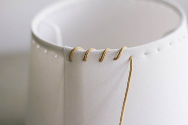 Whipstitching leather cord around rim of IKEA lampshade