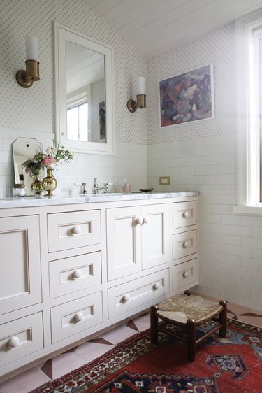 small bathroom wallpaper with blush vanity cabinet and subway tile