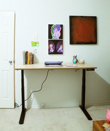 standing desk with art on the wall