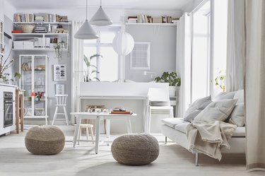 white living room space with shelves and couch