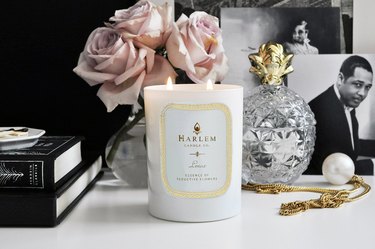 Harlem Candle Co. Lenox Luxury Candle on white table with pink roses