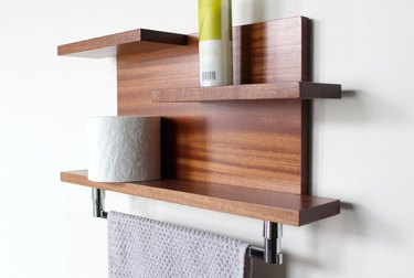 Wood midcentury towel rack for small bathroom and wall shelf with toiletries