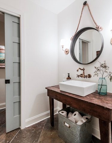 Small light blue bathroom door with white farmhouse bathroom