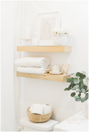 Boho Bathroom Storage in boho wooden open shelving above toilet