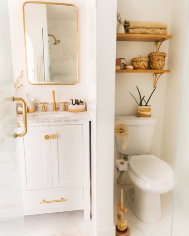 small boho bathroom with brass hardware and open shelving