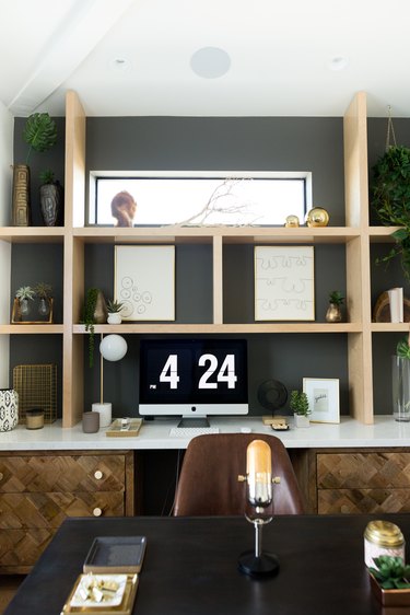 dark gray home office with wood shelves and bohemian decor