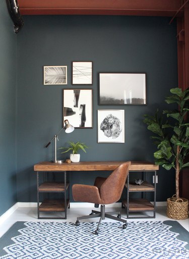 dark gray office with rustic wood desk and leather chair