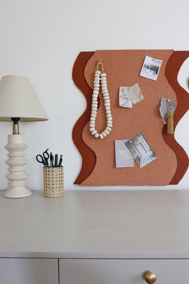 DIY wavy line bulletin board painted with terracotta and salmon colors