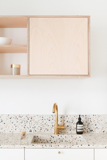 Scandinavian kitchen with terrazzo countertop and integrated sink