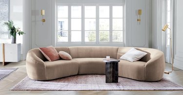 living room with white walls and large sectional sofa in beige color
