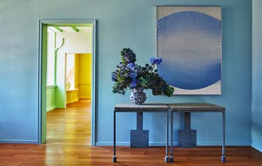 blue room with flowers and painting