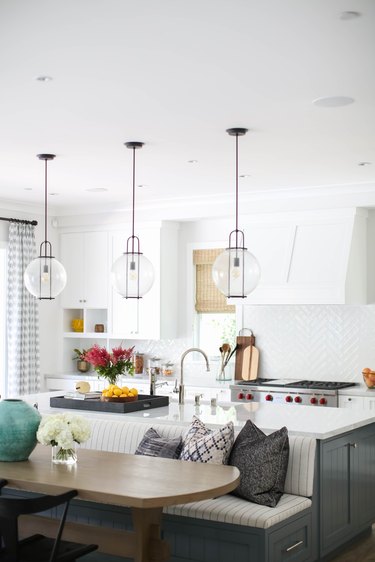 glass globe style lights with black streamlined details in white kitchen