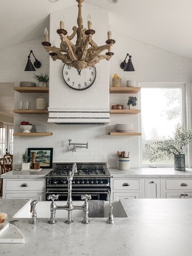 white farmhouse kitchen with wood chandelier above island