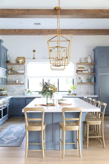 large brass lanterns above blue and white island