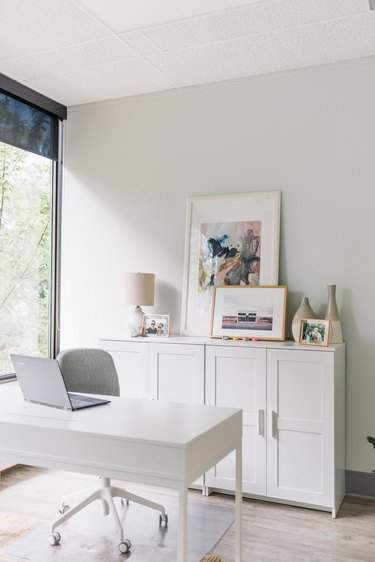light gray office with white cabinets and white desk
