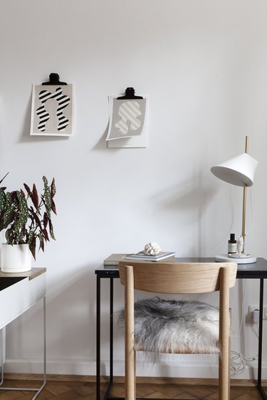 minimalist gray office with simple wall art and wood chair