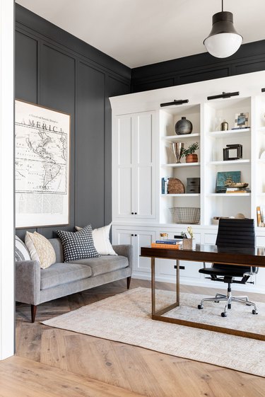 dark gray and white office with white built-ins and modern light fixture