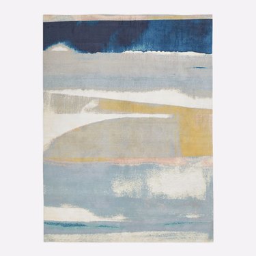 blue, white, and yellow abstract art area rug