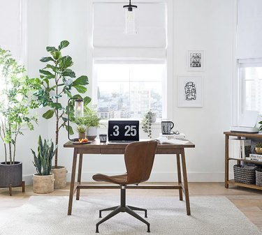 gray jute rug under wood desk in white office