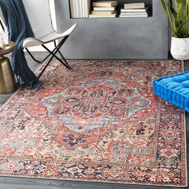 red patterned rug with blue accents