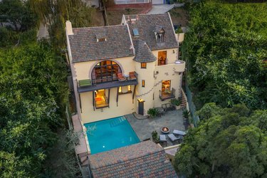 overview photo of storybook home with pool