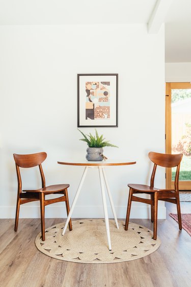 Small round dining table with two chairs