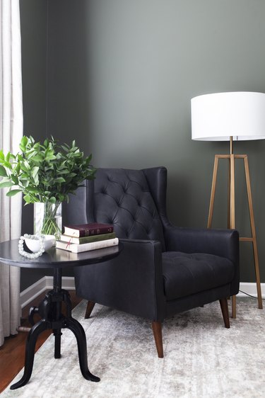 brass floor lamp with white shade in traditional green office